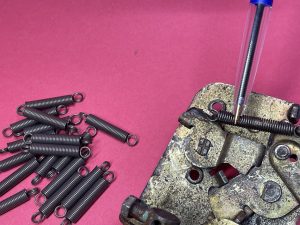 Door lock mechanism spring